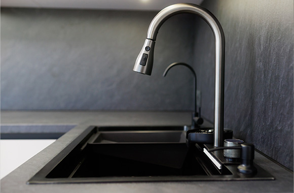 modern kitchen sink with sleek faucet design showcasing water flow and minimalist black aesthetics perfect for luxury home details